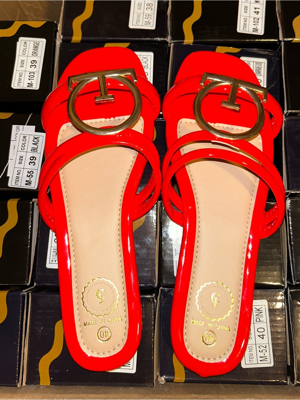 Women’s Red Patent Slide Mules with Gold Emblem